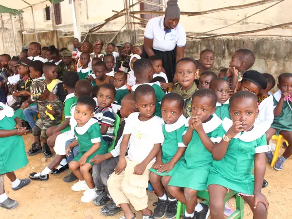 A HEWIS preschool class seated together with their teacher