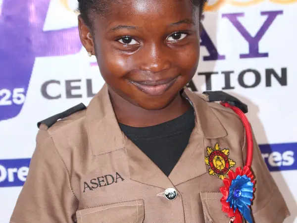 A young HEWIS pupil dressed in a security officer uniform for Career Day